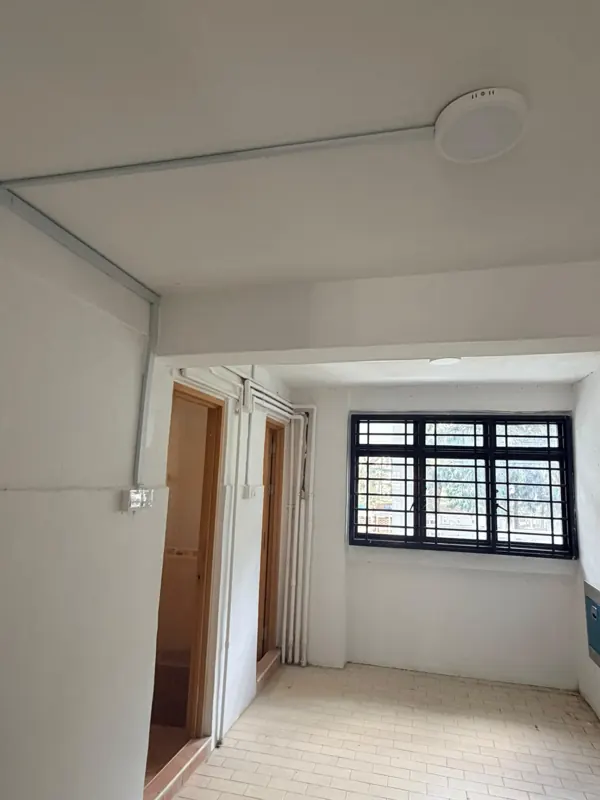 Surface-mounted ceiling conduit and round light fitting in an interior room at Blk 233 Lorong 8 Toa Payoh